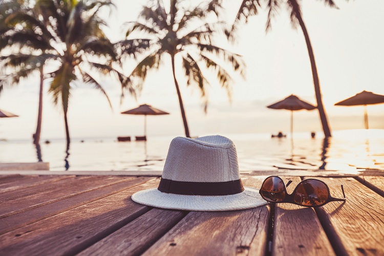 Hat and sunglasses by the pool