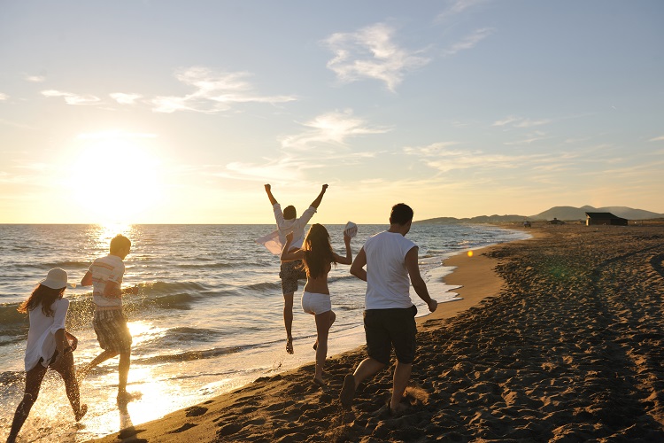 Group of friends at the beach on an all inclusive vacation