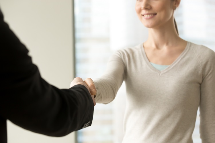 Woman shaking hands with her employer